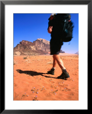 Trekker Hiking Across The Desert Sands Towards Wadi Rum, Jordan by Mark Daffey Pricing Limited Edition Print image