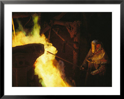 A Man In Protective Gear Tends A Smelter At Magma Metals Company by Joel Sartore Pricing Limited Edition Print image