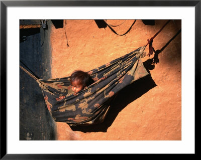 Tharu Child In Hammock Near Karnali River In Western Nepal, Karnali River, Bheri, Nepal by Gareth Mccormack Pricing Limited Edition Print image