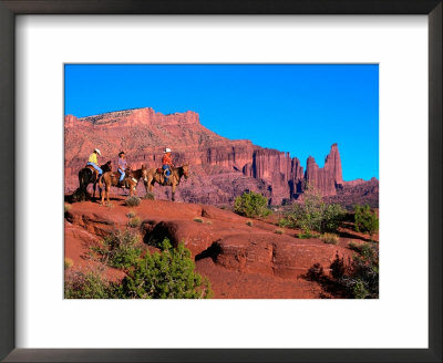Riders On Mules Trail Riding Through Fisher Towers, Moab, Utah, Usa by Curtis Martin Pricing Limited Edition Print image