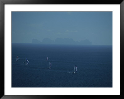Sailboats Race Through Blue Water Past An Island In The Distance by Jodi Cobb Pricing Limited Edition Print image