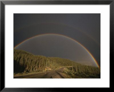 A Rainbow Arches Over The Alaska Highway In British Columbia, Canada by Raymond Gehman Pricing Limited Edition Print image
