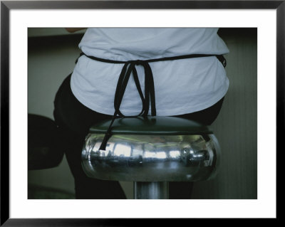 A Waitress Sits On A Shiny Stool That Reflects The Diners Interior by Stephen St. John Pricing Limited Edition Print image