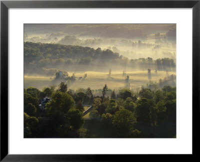 Aerial View Of A Farm At Twilight With Sunlight Streaking Through The Mist by Kenneth Garrett Pricing Limited Edition Print image