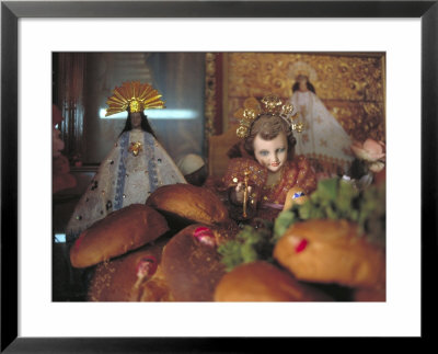 Altar Of Food, Candles, Baby Jesus Statues And The Virgins Of Soledad And Guadalupe, Oaxaca, Mexico by Judith Haden Pricing Limited Edition Print image