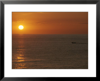 A Boat Passes In Front Of The Setting Sun In Baja, Mexico by Jimmy Chin Pricing Limited Edition Print image