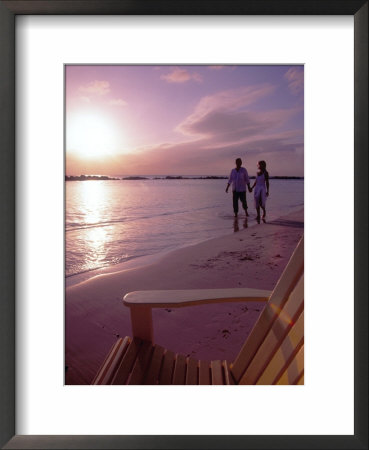 Couple Walking Along Beach At Sunset, Nassau, Bahamas, Caribbean by Greg Johnston Pricing Limited Edition Print image