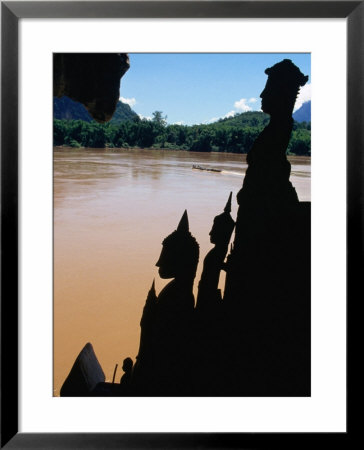 Buddha Statues Along Mekong River At Pak Ou Caves Pak Ou, Luang Prabang, Laos by John Borthwick Pricing Limited Edition Print image