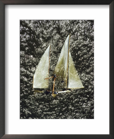 A Sailboat Floats On Its Side After Being Capsized By A Gust Of Wind by Lowell Georgia Pricing Limited Edition Print image