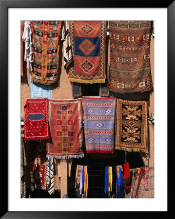 Carpets And Rugs Hanging Outside Shop, Agdz, Morocco by John Elk Iii Pricing Limited Edition Print image