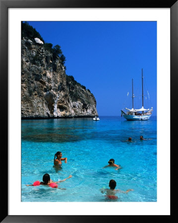 Tourists Swimming In Waters Of Cala Mariolu In Gulf Of Orosei, Sardinia, Italy by Dallas Stribley Pricing Limited Edition Print image