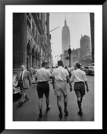 Three Young Businessmen Wearing Bermuda Shorts As They Walk Along Fifth Ave. During Lunchtime by Lisa Larsen Pricing Limited Edition Print image