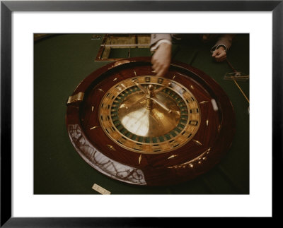 A Patron Spins A Roulette Wheel At A Casino In Monaco by Jodi Cobb Pricing Limited Edition Print image