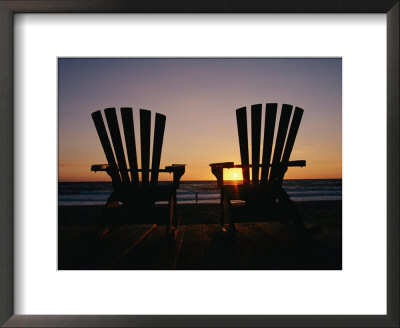 Two Chairs On A Shoreline Facing The Setting Sun by Steve Winter Pricing Limited Edition Print image