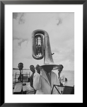 Tuba Player Keeping His Head Dry In A Rainstorm During Visit To St. Croix By Pres. Harry S. Truman by Thomas D. Mcavoy Pricing Limited Edition Print image