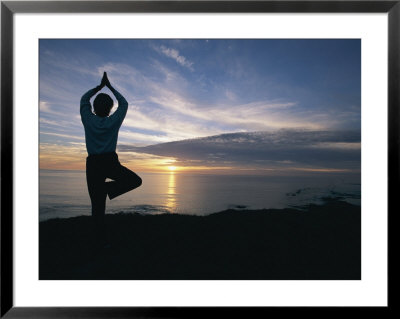 A Woman Practices Yoga On The Beach At Sunset by Roy Toft Pricing Limited Edition Print image