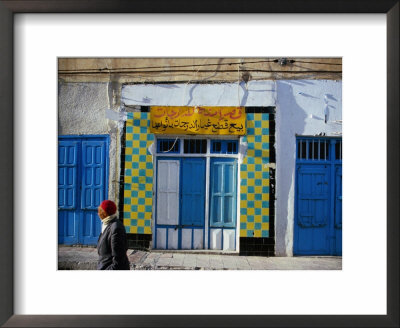 Person Wandering Past Buildings, Gafsa, Gafsa, Tunisia by Martin Llado Pricing Limited Edition Print image