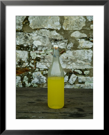 Bottle Of Limoncello Sits On A Picnic Table At A Tuscan Villa, Tuscany, Italy by Todd Gipstein Pricing Limited Edition Print image