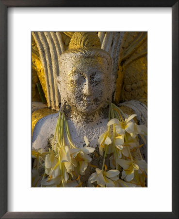 Close Up Of Small Buddha Figure With Flowers Round The Neck In The Shwedagon Paya, Yangon, Myanmar by Eitan Simanor Pricing Limited Edition Print image