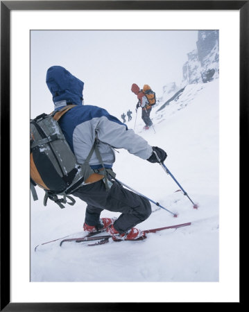 Skiiers Descend The Selkirk Range During A Storm by Jimmy Chin Pricing Limited Edition Print image