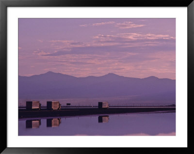 Trucks On The Highway Reflected In Great Salt Lake, Utah by Kenneth Garrett Pricing Limited Edition Print image