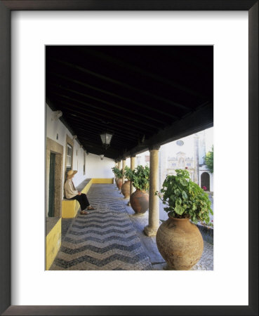 Tourist On Terrace With Striped Cobblestone Floor And Planters, Portugal by John & Lisa Merrill Pricing Limited Edition Print image