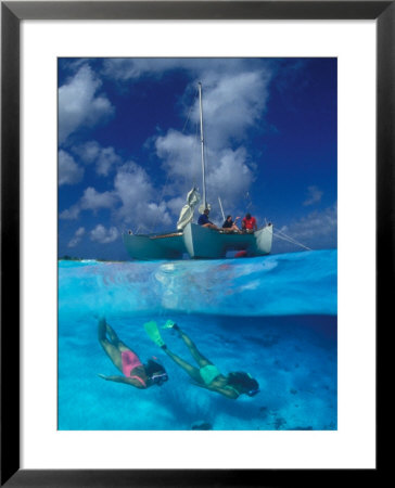 Female Divers Submerged Below Catamaran by Amos Nachoum Pricing Limited Edition Print image