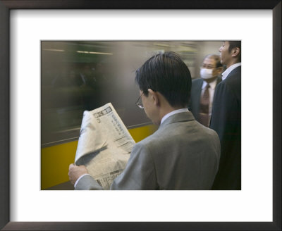 Man Reading Newspaper At Shinjuku Station, Tokyo, Kanto, Japan by Brent Winebrenner Pricing Limited Edition Print image