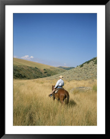 A Cowboy Rides His Horse Looking For Cattle On His Land by Taylor S. Kennedy Pricing Limited Edition Print image