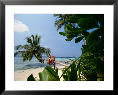 Couple On Beach, Felidu Atoll, Maldives by Stuart Westmoreland Pricing Limited Edition Print image