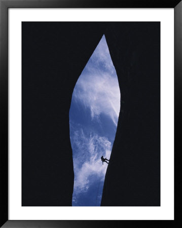 An Expert Canyoneer Rappells Into A Slot Canyon Near Navajo Canyon In Arizona by Bill Hatcher Pricing Limited Edition Print image