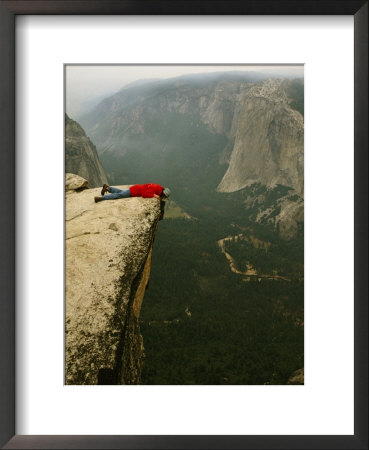 Prone Man Peers Over Taft Point Into The Yosemite Valley by Bill Hatcher Pricing Limited Edition Print image