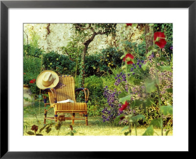 Summer Garden In France With Cane Seat With Stand Of Purple Echinops And Pleached Apple Tree by Martine Mouchy Pricing Limited Edition Print image