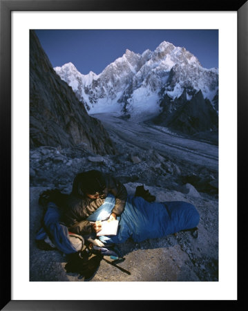 A Man In His Sleeping Bag In Charakusa, Karakoram, Pakistan by Jimmy Chin Pricing Limited Edition Print image