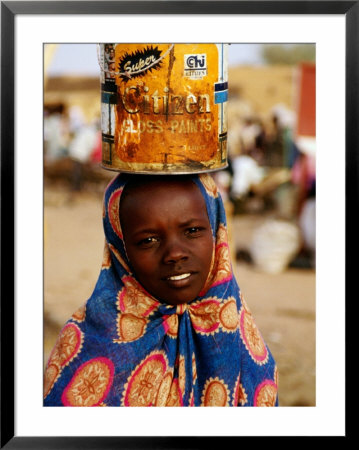 Girl In Colourful Wrap Balancing Paint Tin On Head, Agadez, Niger by Pershouse Craig Pricing Limited Edition Print image
