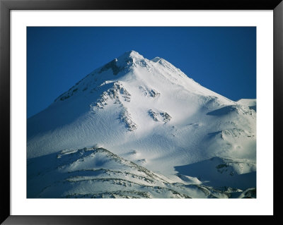 A Snow-Covered Mountain Reaches Toward The Sky by Joel Sartore Pricing Limited Edition Print image