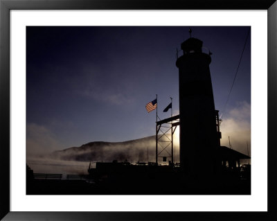 Sunrise On Foggy Otsego Lake Silhouettes A Lighthouse And Flags by Stephen St. John Pricing Limited Edition Print image