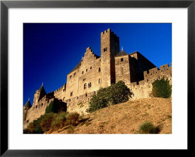 Chateau Comtal And Medieval Walled City Bathed In Late Afternoon Sunlight, Carcassonne, France by Dallas Stribley Pricing Limited Edition Print image