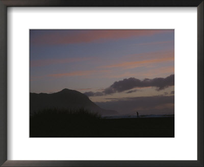 Sunset Over Coastline Of Tasman Sea With Lone Figure Of Hiker by Todd Gipstein Pricing Limited Edition Print image