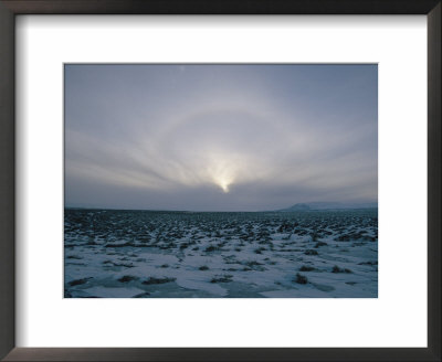 An Aurora Appears As The Sun Sets/Rises Over A Snowy Field by Sisse Brimberg Pricing Limited Edition Print image