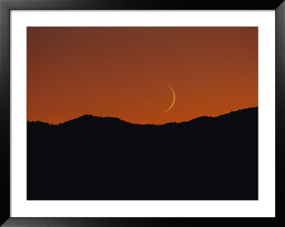 A Crescent Moon Sets Over Mountains Rimming The Western Edge Of Lake Tahoe by George F. Mobley Pricing Limited Edition Print image