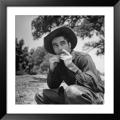 Actor Montgomery Clift Dressed In Cowboy Costume, Rolling Cigarette During Shooting Of Red River by J. R. Eyerman Pricing Limited Edition Print image