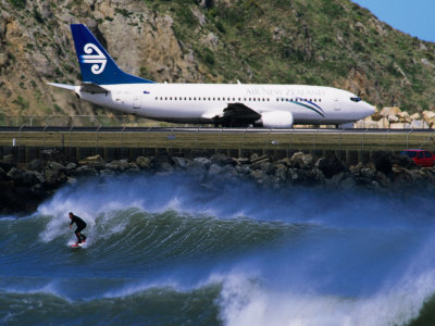 Surfer In The Corner Next To Airport Runway, Lyall Bay, Wellington, New Zealand by Paul Kennedy Pricing Limited Edition Print image