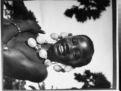 Congolese Native Girl Wearing Necklace Of Photographer's Flashbulbs Strung Together, Belgian Congo by Nat Farbman Pricing Limited Edition Print image