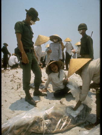 Identifying Remains Of Those Killed In Vietnam War Tet Offensive, Recently Found In Mass Grave by Larry Burrows Pricing Limited Edition Print image