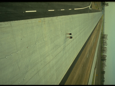 Aerial Of Two Cyclists Dwarfed In Expanse Of Straight Newish Empty 6-Lane Highway by Ralph Crane Pricing Limited Edition Print image