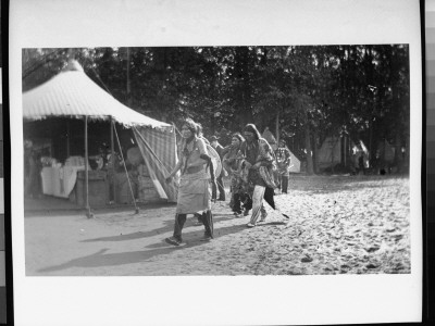 Indians Walking Near Tents On The Grounds Of Buffalo Bill's Wild West Show by Wallace G. Levison Pricing Limited Edition Print image