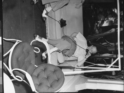 Writer Damon Runyon Sitting On Porch Glider And Talking On Telephone by Gjon Mili Pricing Limited Edition Print image