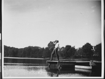 A Man Standing At The Edge Of A Dock, Casting His Fishing Line by Wallace G. Levison Pricing Limited Edition Print image