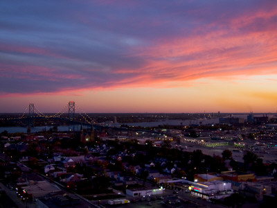 View Of Ambassador Bridge And Neighborhood, Sunset by Geoffrey George Pricing Limited Edition Print image